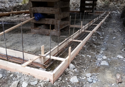 10 After this photo was taken it was decided to drop the rebar a little lower in the footings, and more back fill was added